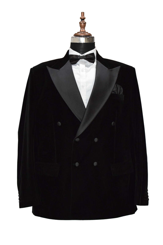 Black velvet smoking jacket with shawl collar and frog closure, perfect for formal occasions.