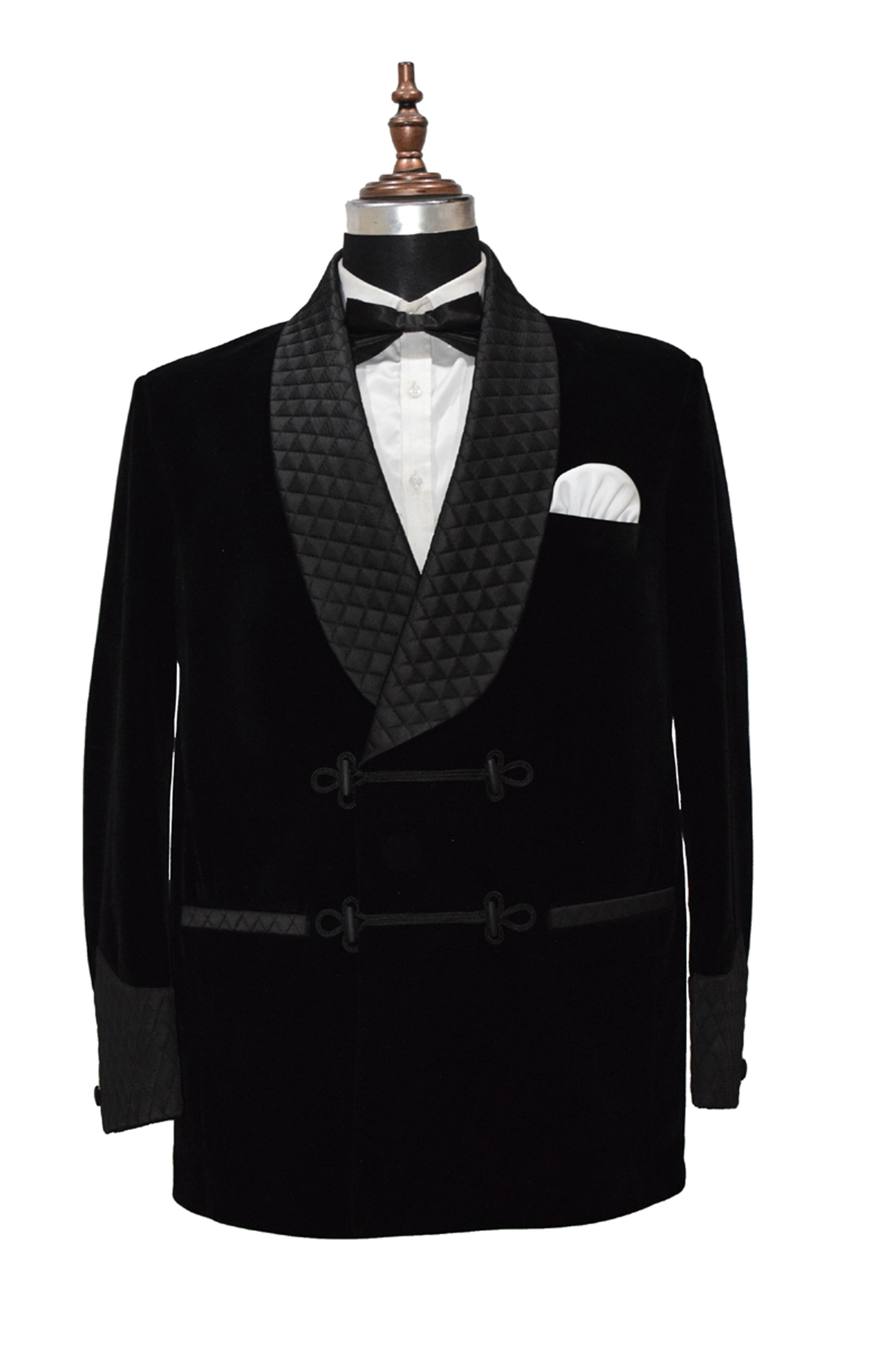 Black velvet smoking jacket with quilted shawl collar and frog closure.