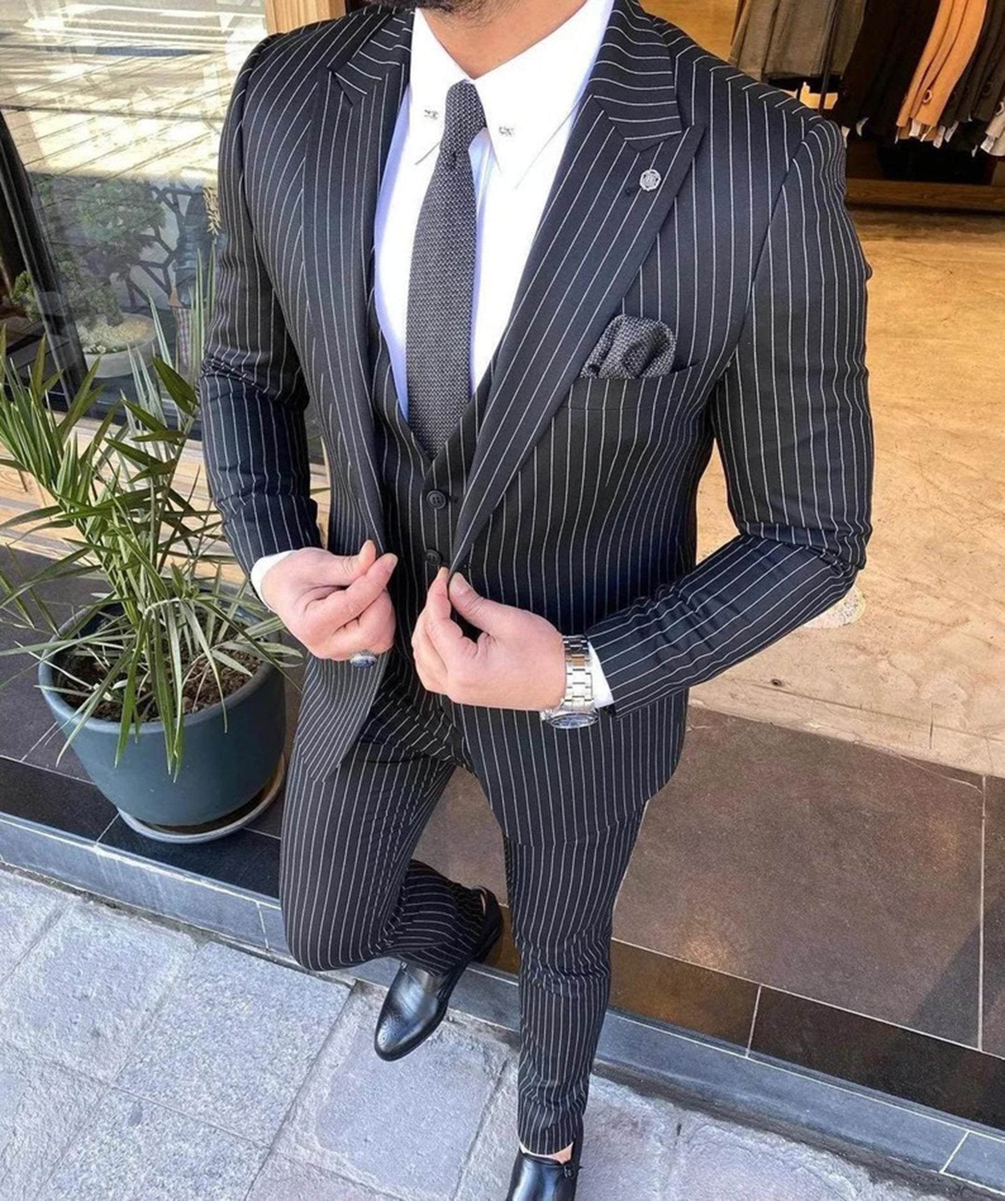 Men elegant black striped three-piece suit for business and weddings.
