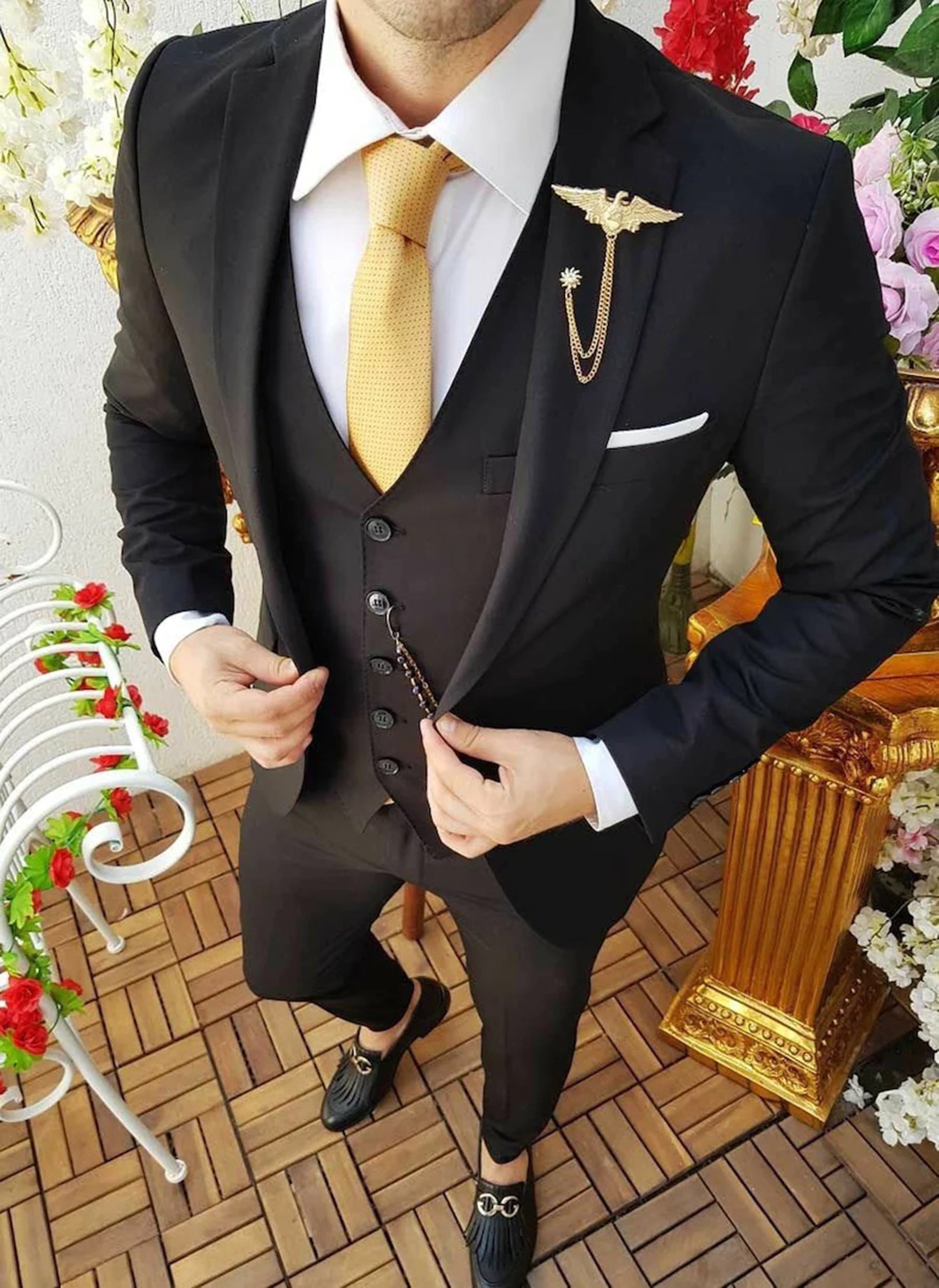 Men elegant black three-piece suit with jacket, trousers, and waistcoat for formal events.