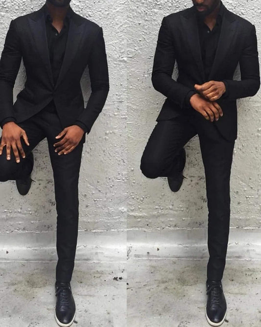 Men's black single-breasted party wear suit with peak lapel and two-button closure, showcasing a modern silhouette.