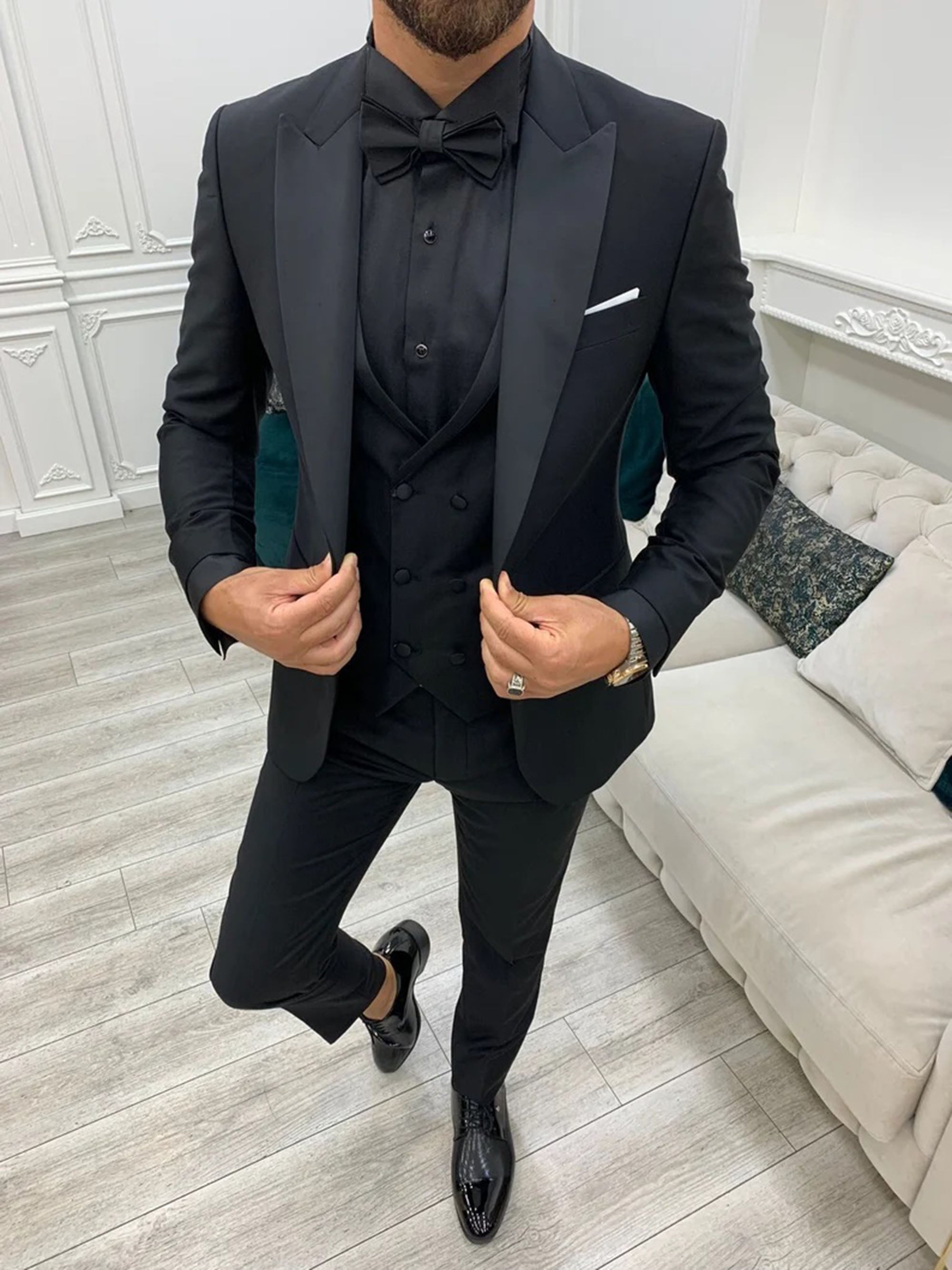 Men's classic black three-piece suit for weddings, featuring a slim fit jacket, trousers, and waistcoat.