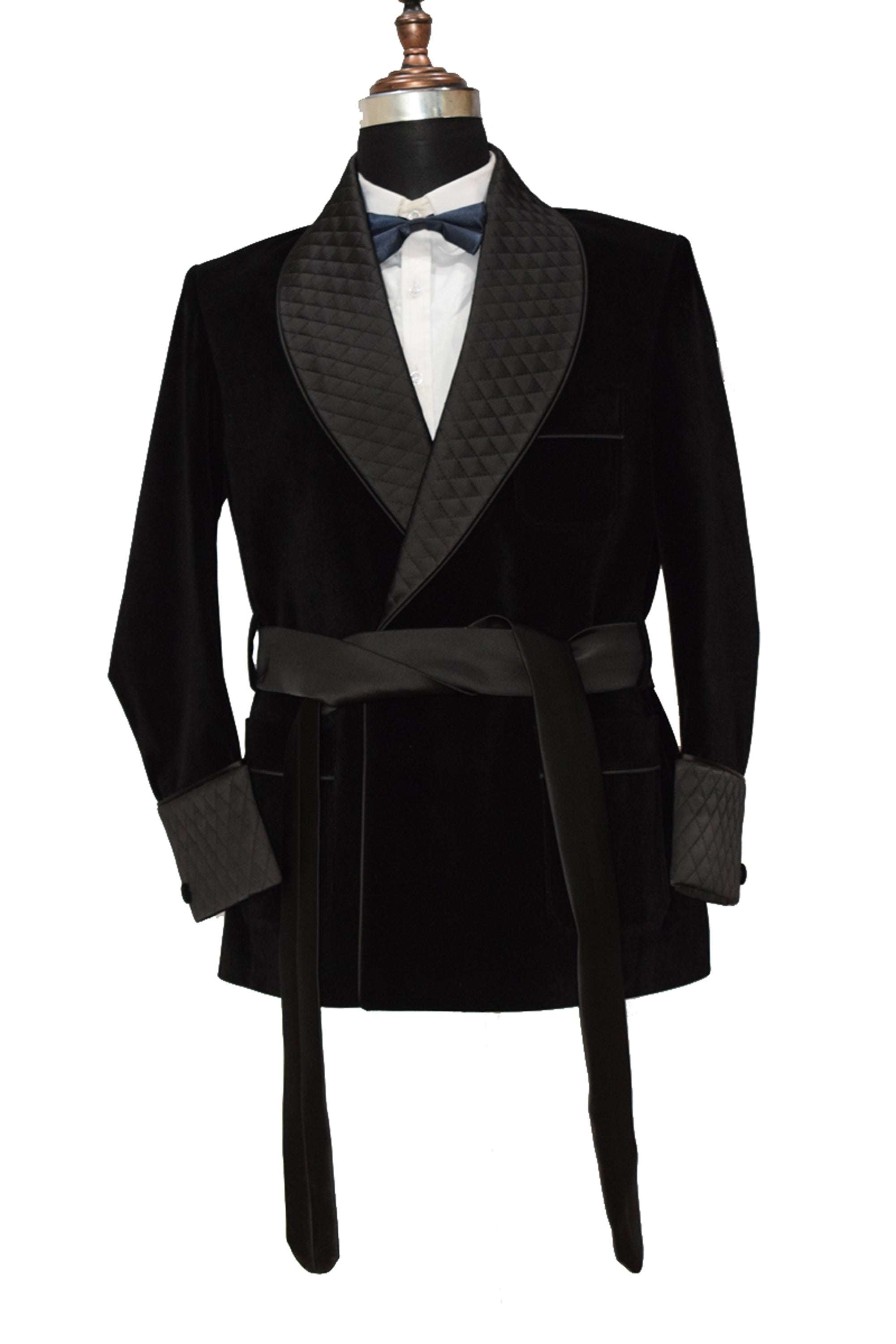Men's black velvet smoking jacket with quilted lapels, cuffs, and satin belt.