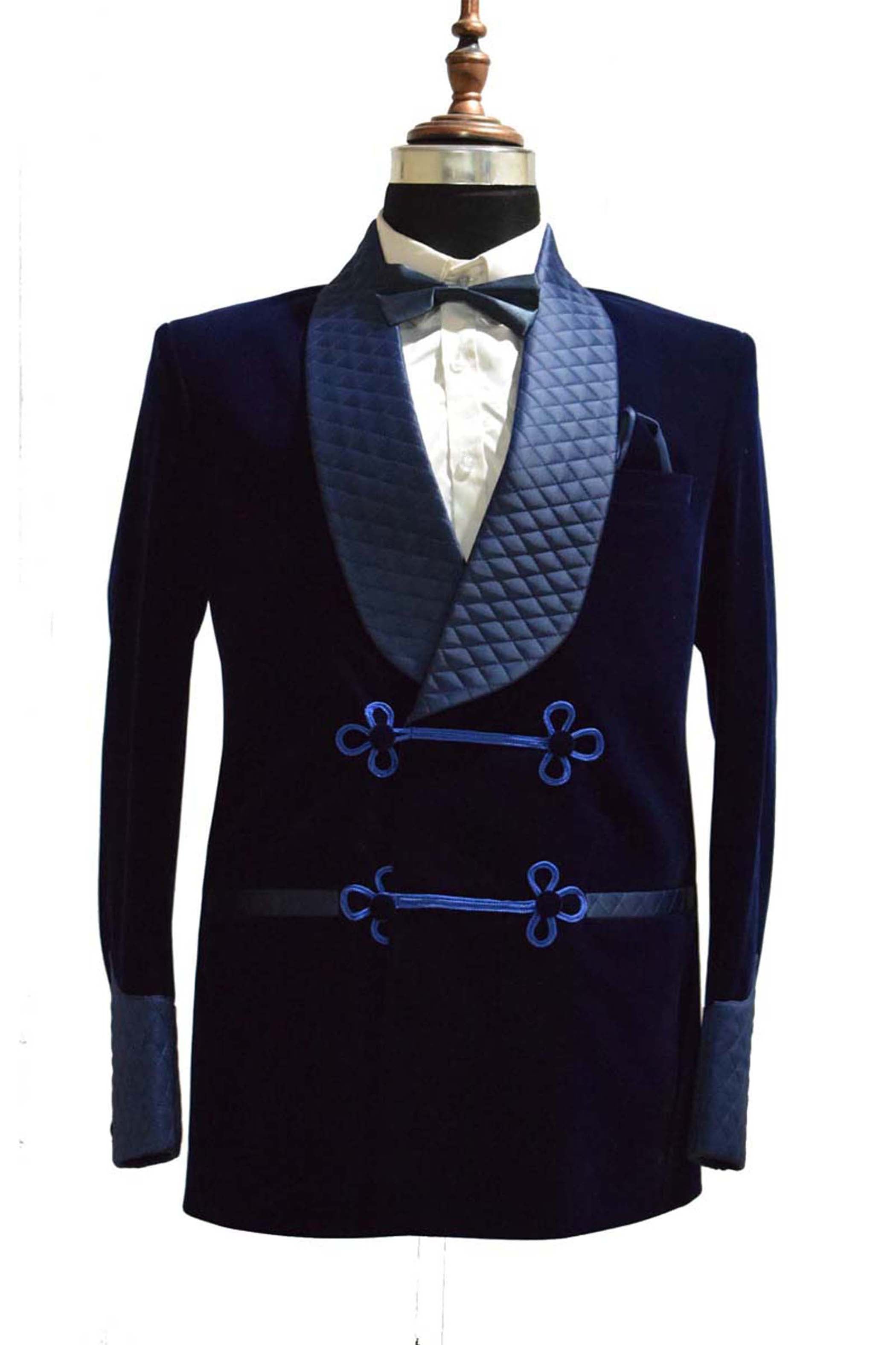 Navy blue velvet smoking jacket with quilted shawl collar and elegant frog closure.